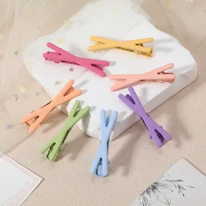 Detailed view of colorful macaron metal duckbill hair clips, cute cross design for daily styling.