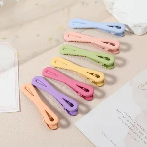 Detailed close-up of colorful macaron metal duckbill hair clips, neat arrangement, matte finish.