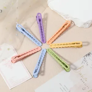 Colorful macaron metal duckbill hair clips with cute hollow wave design for kids and DIY styling.