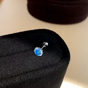 Close-up detail shot of a sparkling blue cubic zirconia stud earring with screw back design.