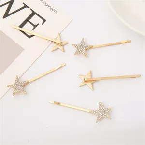 Horquillas doradas de estrella con diamantes de imitación de 7cm para flequillo.