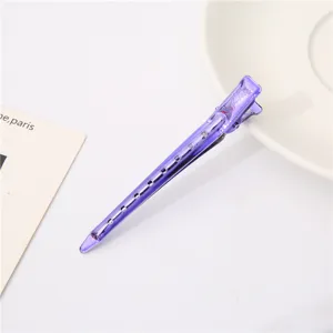 Detailed close-up view of the purple translucent plastic duckbill hair clip with hollow design.