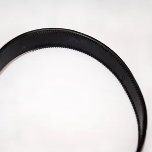 Close-up detail of black plastic teeth headband showing inner anti-slip design and durable material structure.