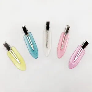 Detailed shot of colorful candy color resin duckbill hair clips with sparkling glitter.