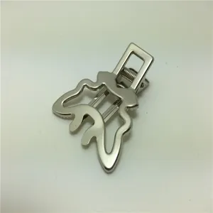 Close-up detail of silver metal duckbill hair clip showing polished finish and unique shape.