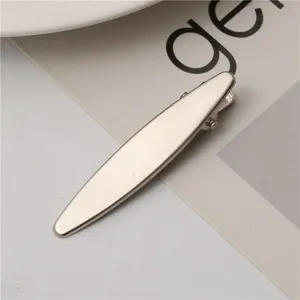 Metal duckbill hair clip detail shot, elegant side hair accessory with brushed texture.