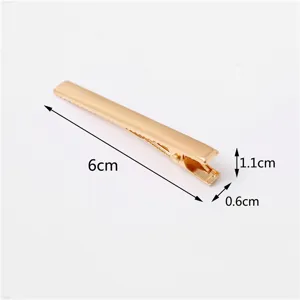 Dettaglio molletta per capelli becco d'anatra in metallo dorato, lunghezza elegante di 6cm.