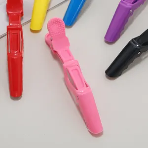 Detail shot of colorful plastic hair sectioning clips, professional hairdressing tool accessory.