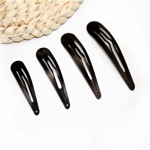 Set of four black metal snap hair clips in graduated sizes for daily hairstyling accessories.