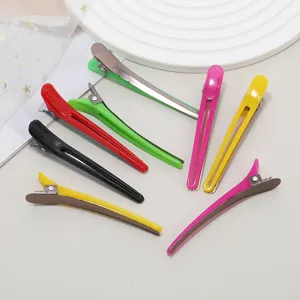 Detailed view of colorful hair sectioning clips, durable metal spring and anti-slip teeth.