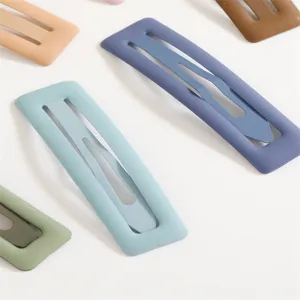 Close-up detail view of colorful matte pastel square snap hair clips with smooth finish.