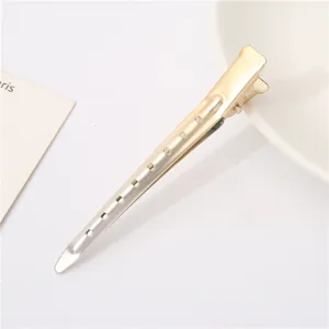 Metal hairdressing duckbill clip, sectioning styling tool detail view, professional salon use.