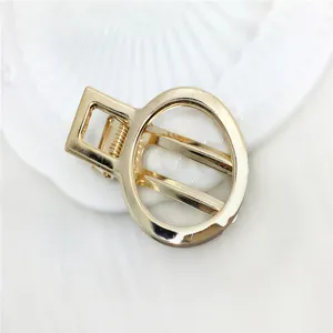 Gold hollow geometric hair claw clip detail, 5cm metallic alloy DIY hair accessory material for women.