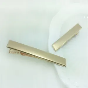 Detailed view of two elegant gold rectangle hair clips, minimalist metal design for women and DIY.