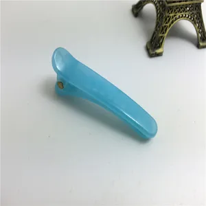 Detail view of a 5cm light blue plastic duckbill hair clip, simple accessory for styling.