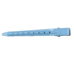 Detailed close-up of light blue metal duckbill hair clip with sectioning holes for styling.