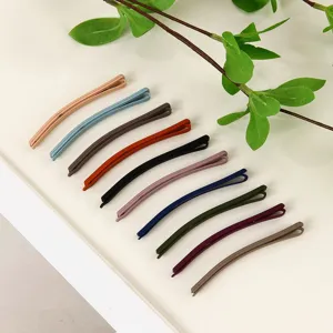 Close-up detail shot of colorful matte bobby pins, showing smooth texture and various colors.