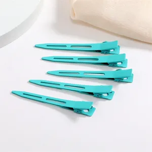 Close-up detail shot of candy color metal hair duckbill clips, neat arrangement, soft texture.