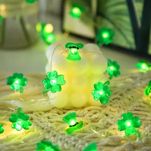 Close-up detail of St. Patrick's Day LED string lights with green clover and hat charms.