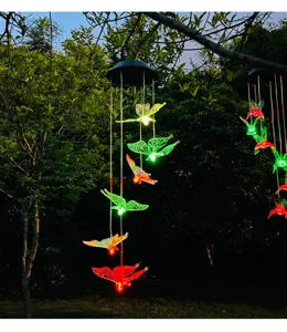 Detalle de carillón de viento solar LED, decoración colgante de mariposa luminosa jardín.