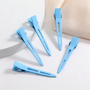 Close-up detail of light blue metal duckbill hair clips featuring hollow design and soft touch.