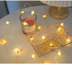 Dettaglio di luci a LED in filo di rame con simpatiche forme di coniglietti e carote.