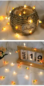 Catena luminosa a LED in filo di rame con carote e coniglietti, ideale per decorazioni festive.
