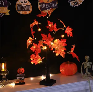 Halloween LED maple tree light detail view showing glowing autumn leaves and festive holiday props.