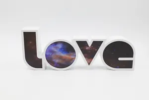 Detail shot of a white LED love letter night light with stunning starry sky pattern interior design.