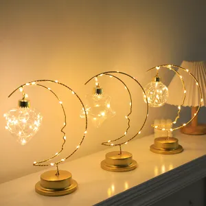 Iron art moon night light with hanging pendant LED fairy lights for cozy bedroom decor.