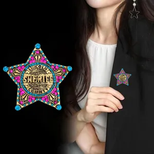 Detailed shot of star sheriff badge brooch with colorful rhinestones and metal finish.