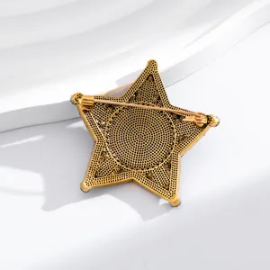 Vintage gold sheriff star brooch detailed back view, classic metal pin badge accessory.