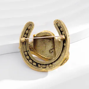 Vintage gold horseshoe cowboy hat brooch back detail showcasing secure pin clasp metal craft.