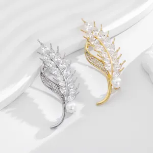 Luxury wheat ear brooch with sparkling cubic zirconia and pearl, elegant suit pin accessory.