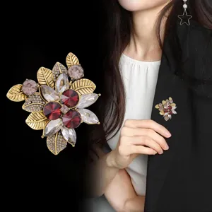 Vintage crystal flower brooch detail, elegant red rhinestone pin for women's apparel.