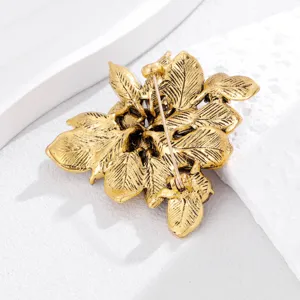 Detailed view of the vintage gold leaf brooch back structure, showing pin craftsmanship and texture.