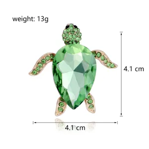 Green crystal turtle brooch detail, elegant rhinestone animal lapel pin for women fashion clothes.