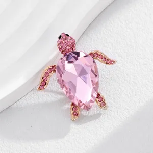 Exquisite crystal sea turtle brooch detail with pink rhinestone and gold tone metal pin.