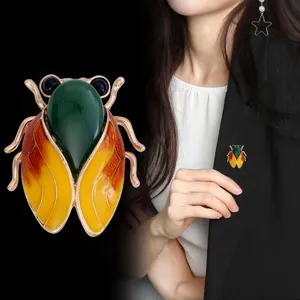Exquisite Chinese style cicada brooch with jade-like stone and enamel wings for women outfit.