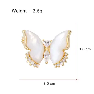 Elegant mother of pearl butterfly brooch in gold plated copper with sparkling cubic zirconia.