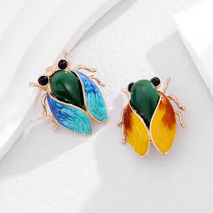Close-up detail shot of Chinese style enamel cicada brooch featuring jade-like green body.