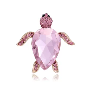 Elegant pink crystal turtle brooch pin, shining rhinestone gold tone animal lapel jewelry accessory.