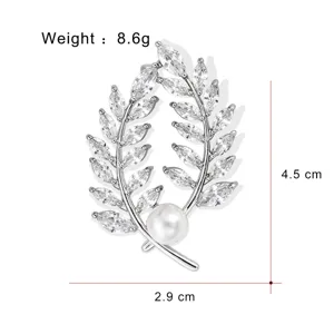 Detailed view of the elegant wheat leaf brooch with sparkling cubic zirconia and pearl.