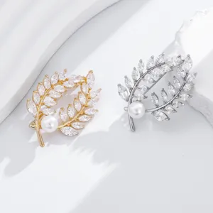Exquisite leaf shaped brooch detail with sparkling cubic zirconia and elegant pearl accent.