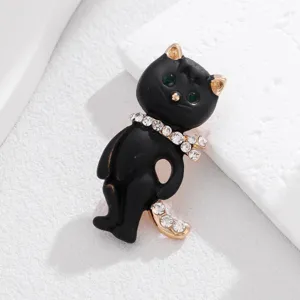 Elegant black cat brooch featuring sparkling rhinestones and green crystal eyes for women.