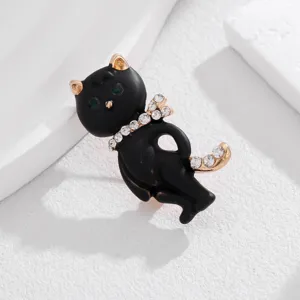Charming black cat brooch with sparkling rhinestones and green eyes, elegant fashion pin.