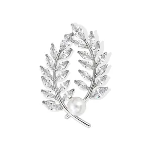 Exquisite wheat ear brooch featuring sparkling cubic zirconia and pearl, elegant suit accessory.