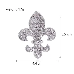Close-up detail of silver rhinestone fleur-de-lis brooch showing dimensions and weight.