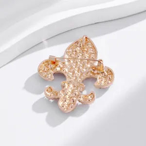 Detailed back view of vintage rose gold alloy fleur-de-lis brooch pin accessory.