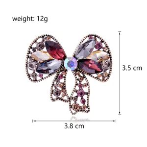 Vintage crystal bow brooch for women, elegant rhinestone fashion apparel accessory.